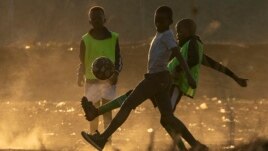 Children play soccer in June 2021 in the dirt east of Johannesburg in South Africa. FIFA says its Football for Schools program is more important for the game of soccer than the upcoming World Cup. (AP)