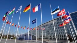 FILE - Flags of member nations at NATO headquarters.