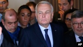 French Foreign Minister Jean-Marc Ayrault (center) arrives at Charles de Gaulle airport's Mercure hotel where passenger relatives have been met by EgyptAir representatives.
