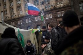 A Russian flag waves on a tent set by anti-Yanukovych protesters in Kiev's Independence Square, the epicenter of the country's current unrest, Ukraine, Saturday, March 1, 2014.