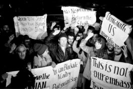 Americans who support Iran's position in the hostage crisis join with Iranians in anti-American demonstrations outside the U.S. Embassy in Tehran , Dec. 15, 1979. (AP Photo/Mohammad Sayad)