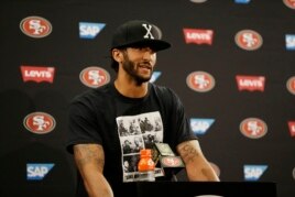 San Francisco 49ers quarterback Colin Kaepernick answers questions at a news conference after an NFL preseason football game against the Green Bay Packers.