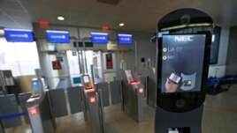 A U.S. Customs and Border Protection facial recognition device is shown at a United Airlines gate, Wednesday, July 12, 2017, at George Bush Intercontinental Airport, in Houston. (AP Photo/David J. Phillip)