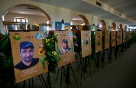 In this Friday, Feb. 1, 2019 photo, commemorative images of militiamen who died fighting the Islamic State group over the past four years, and their weapons are on display in the Popular Mobilization Forces War Museum on al-Mutanabi Street, Baghdad, Iraq.