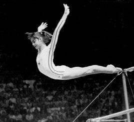 Romania's Nadia Comaneci dismounts from the uneven parallel bars to score a perfect 10.00 in the Women's Gymnastic Olympic competition in Montreal, July 18, 1976. (AP Photo/Suzanne Vlamis)