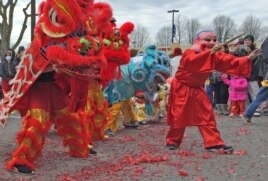 FILE - A dragon dance at Eden Center to celebrate the New Year of the Rooster