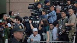 In this Wednesday, Feb. 27, 2019 photo, journalists gather outside Metropole hotel where U.S President Donald Trump and North Korean leader Kim Jong Un are to have their meeting in Hanoi, Vietnam. (AP Photo/Vincent Yu)