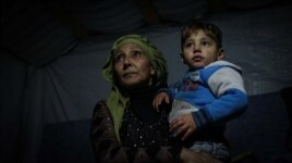 Mother of eight Najah Ali has been living in the camp for two years. Her husband died in Syria and she struggles to provide for her family - she cannot afford fuel for a heater. (John Owens for VOA)