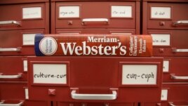 FILE - A Merriam-Webster dictionary sits atop their citation files at the dictionary publisher's offices on Dec. 9, 2014, in Springfield, Mass. Merriam-Webster's word of the year for 2023 is 