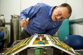 Christopher Ruf, Director of the Space Physics Research Laboratory and Atmospheric, Oceanic and Space Sciences Professor at the University of Michigan, inspects CYGNSS, February 12, 2015.