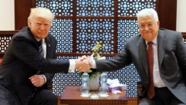 U.S. President Donald Trump (L) and Palestinian President Mahmoud Abbas shake hands before beginning their meeting at the Presidential Palace in the West Bank city of Bethlehem, May 23, 2017.