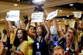 Protesters yell as DNC Chairwoman, Debbie Wasserman Schultz, D-Fla., arrives for a Florida delegation breakfast, Monday, July 25, 2016, in Philadelphia, during the first day of the Democratic National Convention. (AP Photo/Matt Slocum)