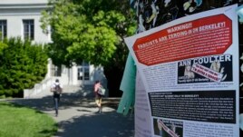 FILE - A leaflet is seen stapled to a message board near Sproul Hall on the University of California, Berkeley in Berkeley, Calif. Students who invited Ann Coulter to speak on campus filed a lawsuit, April 24, 2017, against the university.