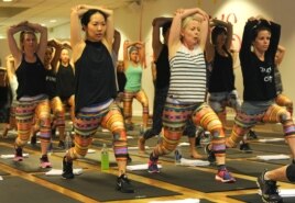 Women wear leggings while practicing yoga.