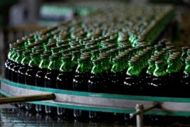 FILE - Bottles of beer move along a production line at a factory of Saigon Beer Corporation (Sabeco) in Hanoi, Vietnam, June 23, 2017.