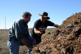 FILE: Jeffrey Creque (L) examines Marin Carbon Project ranch partner Loren Poncia's (R) compost at the Stemple Creek Ranch before spreading it on the area.