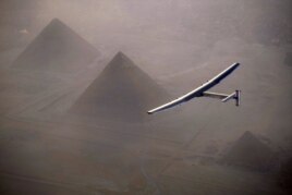 This handout photo released by Solar Impulse 2 shows the solar powered plane, piloted by Swiss pioneer Andr<I>&#</I>233; Borschberg, during the flyover of the pyramids of Giza on July 13, 2016 prior to landing in Cairo, Egypt.