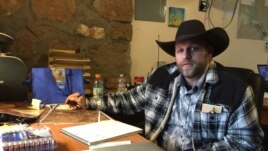 Ammon Bundy sits at a desk he's using at the Malheur National Wildlife Refuge in Oregon, Jan. 22, 2016.