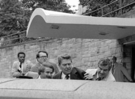 Reagan, pictured here entering the car that took him to the hospital, did not realize at first that he was shot. The gunman was found to be too mentally unstable to be held responsible for the crime. (AP Photo/Ron Edmonds)