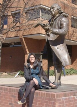 Soulin Reyes at the George Mason statue. It is considered good luck to rub the statue's foot.