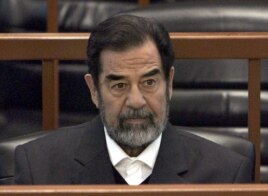 FILE - In this Dec. 6, 2006 file photo, former Iraq leader Saddam Hussein sits in court in Baghdad, Iraq, during the 