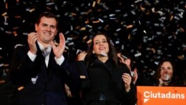 Catalan Ciudadanos leader Ines Arrimadas, center, smiles next to Ciudadanos national leader Albert Rivera at a Ciudadanos rally after results were announced in Catalonia's regional elections in Barcelona, Spain, Dec. 21, 2017.