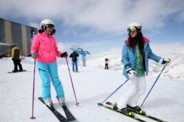 If you are lucky to live near a mountain, skiing is a great exercise. Here, Iranian skiers laugh at a ski resort north of the capital Tehran, Iran, March 2018.