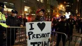 A supporter of President-elect Donald Trump shouts back at opposing demonstrators during a protest against the president-elect in Manhattan, New York, Nov. 11, 2016.