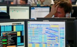 Traders from BGC, a global brokerage company in London's Canary Wharf financial centre react as European stock markets open early June 24, 2016 after Britain voted to leave the European Union