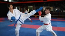 This picture taken on May 11, 2021 shows Afghan-born refugee and karate competitor Asif Sultani (L) training on the outskirts of Sydney as he competes for a place on the Refugee Olympic Team at the...