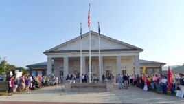 A gathering of same sex marriage supporters, left, and supporters of Rowan County Clerk Kim Davis, right, face off in front of the Rowan County Courthouse in Morehead, Ky., Sept. 1, 2015.