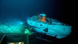 The Pisces IV submersible sits on top of Cook seamount, as seen from the Pisces V craft, during a dive to the previously unexplored underwater volcano off the coast of Hawaii's Big Island on Sept. 6, 2016. Seamounts are places scientists are finding new species. (AP Photo/Caleb Jones)