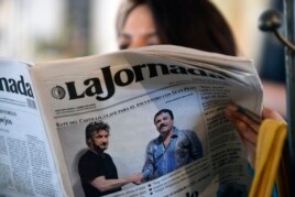 A woman reads La Jornada newspaper in Mexico City, on January 10, 2016 which shows a picture of drug lord Joaquin Guzman, aka 