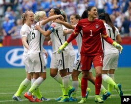 United States' Carli Lloyd (3-L) celebrates with teammates, including goalkeeper Hope Solo (1), after Lloyd scored her third goal against Japan during the first half of the Women's World Cup soccer championship in Vancouver, Canada, July 5, 2015. (AP Photo/Elaine Thompson)