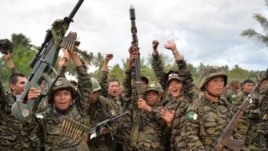 Moro Islamic Liberation Front (MILF) rebels celebrate the signing of the peace agreement during a rally at Camp Darapanan, Sultan Kudarat town, in southern island of Mindanao, March 27, 2014.