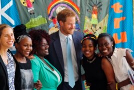 Britain's Prince Harry was among other famous people who spoke at the conference, 2016. He is pictured with young AIDS Ambassadors. (AP Photo)