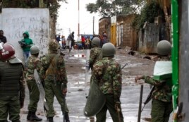 An opposition supporter throws a stone at riot police in Kibera Slums in Nairobi, Kenya, Thursday, Oct. 26, 2017.