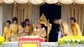 In this file photo, Thai King Bhumibol Adulyadej is surrounded by his family members (L-R) Princess Somsavali, his daughter Princess Ubolratana, his daughter Princess Chulabhorn, Princess Siribhachudabhorn, Royal Consort Princess Srirasm, his grandson Prince