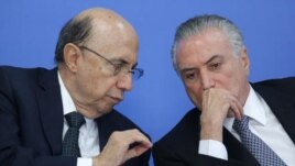 Brazil's acting President Michel Temer, right, talks with his Economy Minister Herinque Meirelles.