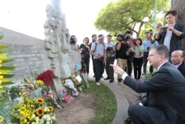 US Ambassador to Vietnam Daniel J. Kritenbrink pays tribute before a sculpture depicting the capture the then-US Navy pilot John McCain whose fighter jet was shot down in 1967, near Truc Bach lake in Hanoi on August 27, 2018.