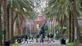 FILE - People walk past a bronze elephant on the grounds of the Audubon Zoo in New Orleans Tuesday Feb. 14, 2006. The Zoo is open only on weekends since Hurricane Katrina struck the city in August. (AP Photo/Bill Haber)