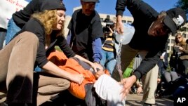 Protesters simulate the use of waterboarding on a volunteer at an anti-torture rally in front of the Justice Department in Washington, Nov. 5, 2007.  (AP Photo/Manuel Balce Ceneta)