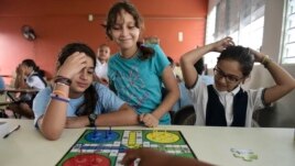 Girls play a board game at the Ramon Marin Sola Elementary School, which opened its doors as a daytime community center after the passing of Hurricane Maria in Guaynabo, Puerto Rico, Oct. 13, 2017. 