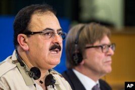 Chief of Staff of the Free Syrian Army Gen. Salim Idris addresses the media after he discussed the situation in Syria with the leader of the Group of the Alliance of Liberals and Democrats for Europe Guy Verhofstadt, right, at the European Parliament.