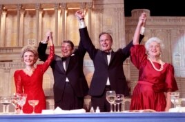 President Ronald Reagan (2nd L) and Vice President George Bush, (2nd R), accompanied by wives Nancy (L) and Barbara, join hands after the President endorses Bushes run for the Presidency