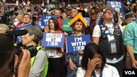 A Hillary Clinton supporter stands next to a Bernie Sanders supporter at the Democratic National Convention, July 26, 2016.