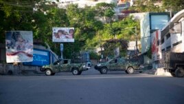 Military vehicles block the entrance to Petion Ville, the neighborhood where the late Haitian President Jovenel Moise lived in Port-au-Prince, Haiti, Wednesday, July 7, 2021. (AP Photo/Joseph Odelyn)