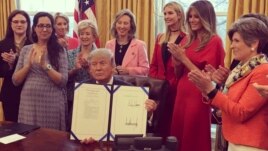 President Donald Trump at the White House, signing two laws that authorize NASA and the National Science Foundation to encourage women and girls to get into STEM fields.