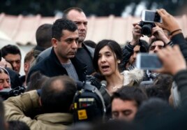 FILE - Former Islamic State captive Iraqi Yazidi Nadia Murad, center, speaks during a visit in a makeshift refugee camp at the northern Greek border point of Idomeni, Greece, April 3, 2016.
