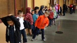 A first grade class of 30 children waits to enter a classroom Thursday, Jan. 24, 2013, at the Willow Glenn Elementary School in San Jose, California. (AP Photo/Ben Margot)